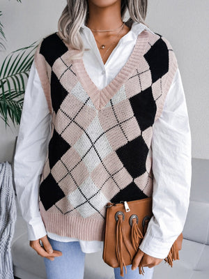 Argyle knit v-neck sweater vest in dusty pink, black, and white, styled with a white shirt.