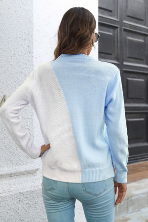 Diagonal knit colorblock sweater in light blue and white acrylic with crew neck and long sleeves.