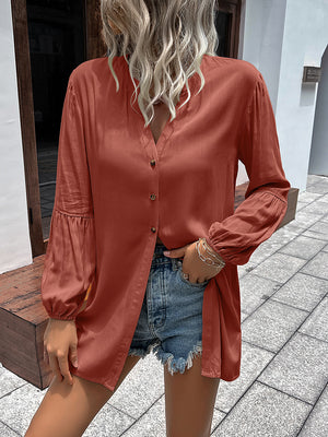 Oversized rust blouse with mandarin collar, button front, and balloon sleeves.
