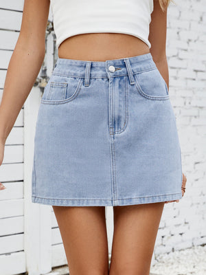 Light wash denim mini skirt with classic five-pocket styling and button fly.
