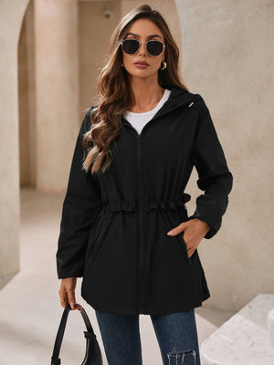 Black hooded windbreaker jacket with ruffled waistline and zippered pockets