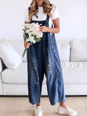 Ripped relaxed fit denim overalls in dark blue with wide legs and button closures.