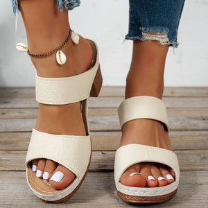 Beige textured strap block heel sandals with shell anklet detail.