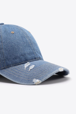 Denim baseball cap in light blue with distressed details and adjustable strap.
