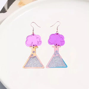Fuchsia pink acrylic dangle earrings shaped like science beakers with glitter and cloud tops.