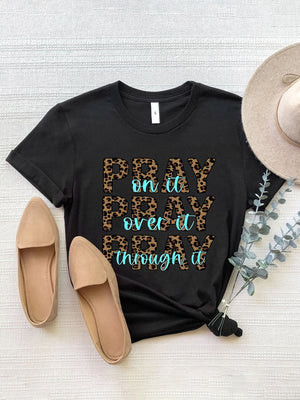 Black graphic tee with leopard print text "PRAY on it PRAY over it PRAY through it