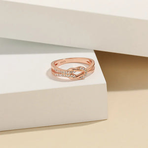 Rose gold knot ring with pave zirconia detail and double band.