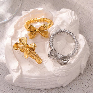 Gold and silver textured bow knot rings with twisted bands