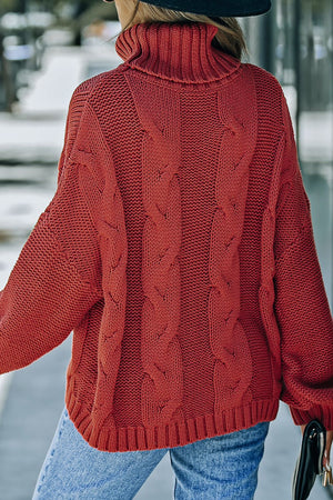 Cable knit turtleneck sweater in rust, featuring a relaxed fit and chunky cable details.
