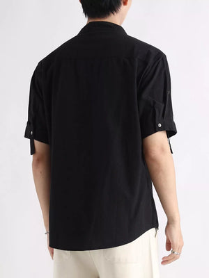 Black cotton button-down shirt with rolled-up short sleeves and a mandarin collar.