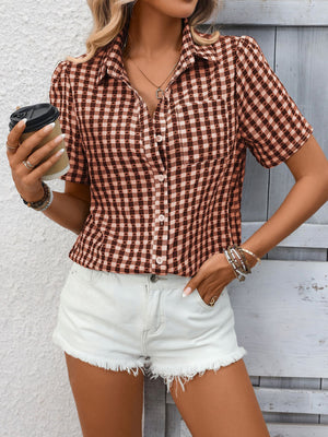 Gingham short-sleeve button-up shirt in Rust Red with a collared neckline and chest pocket.