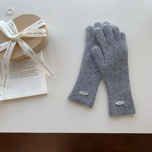 Gray ribbed knit touchscreen gloves with fuzzy trim and oval logo detail.