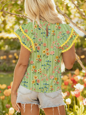 Floral printed cotton blouse with ruffle sleeves and yellow trim.