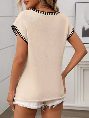 Tan knit top with black striped trim on neckline and sleeves.
