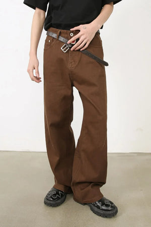 Coffee brown wide-leg denim jeans with angled seams and a relaxed fit.