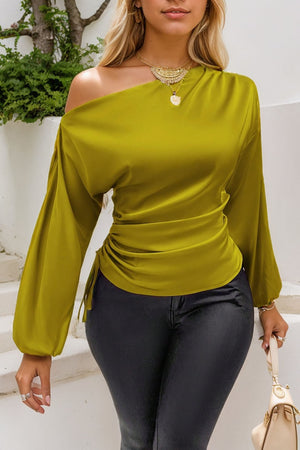 Matcha green asymmetric blouse with drape-front and ruched side detail.