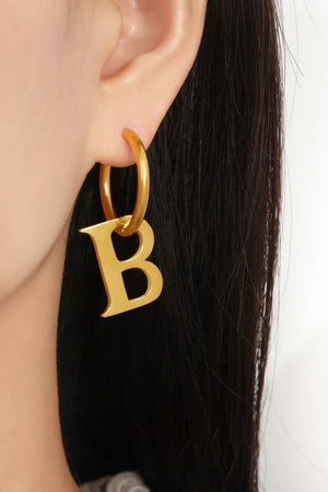 Gold initial letter B hoop earrings with a polished finish.