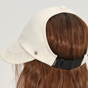 Beige visor hat with adjustable strap and decorative stitching