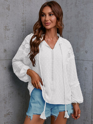 White textured blouse with lace trim and tie neck, long sleeves