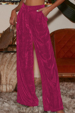 Velvet palazzo trousers in hot pink with a high waist and wide leg.