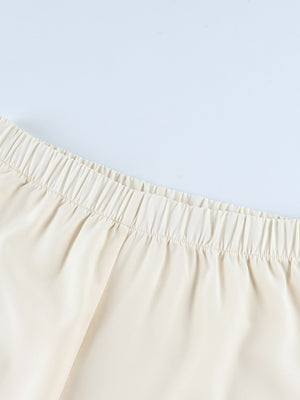 Cream lounge set pants with elastic waistband and black piping detail.