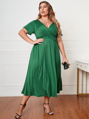 Emerald twist-front midi dress in dark green polyester with a V-neck and short sleeves.