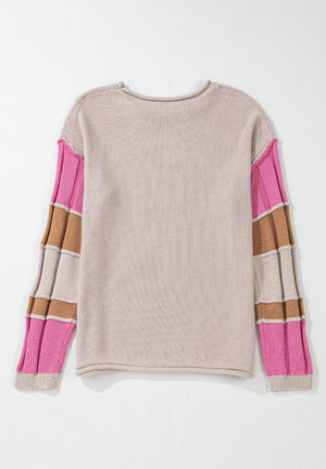 Beige knit sweater with color block panel sleeves in pink and brown.
