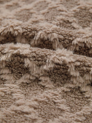Textured sherpa fleece fabric in a taupe color with a soft, fuzzy pile.