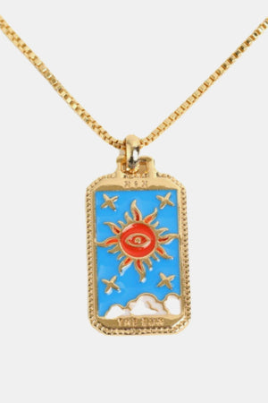 Celestial tarot pendant necklace with sun design, gold chain, and blue enamel.