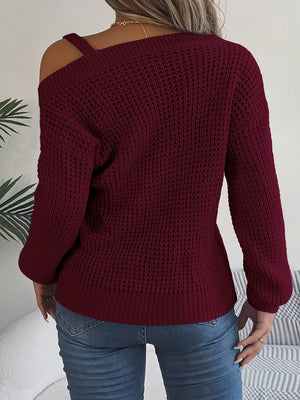 Wine one-shoulder knit sweater with buckle detail and waffle texture.