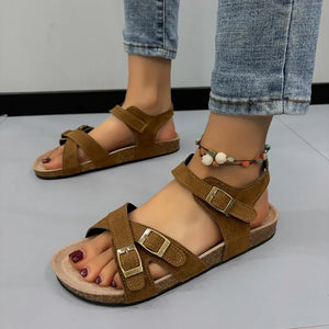Suede crossover buckle cork sandals in mocha with adjustable straps and a cork footbed.