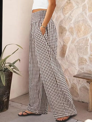 Gingham wide-leg maternity pants in black plaid with a smocked waistband and pockets.