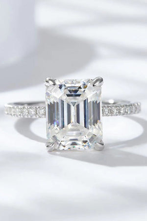Sparkle Luxe Moissanite Halo Ring in silver with an emerald-cut center stone and pavé band.