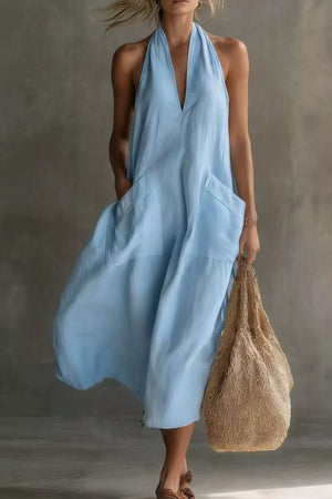 Light blue halter midi dress with pockets and a V-neckline.