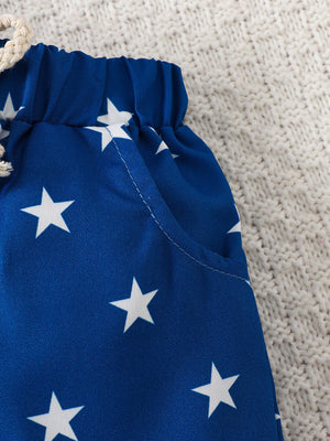 Blue cotton baby shorts with white stars and drawstring waist.