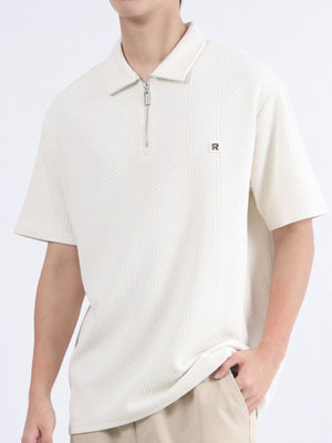 Textured apricot polo shirt with zipper detail and short sleeves