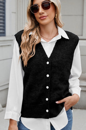 Black button-front knit vest with V-neck and shoulder detail, styled over a white shirt.