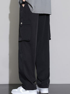Men's black relaxed fit cargo sweatpants with snap-button pocket detail.