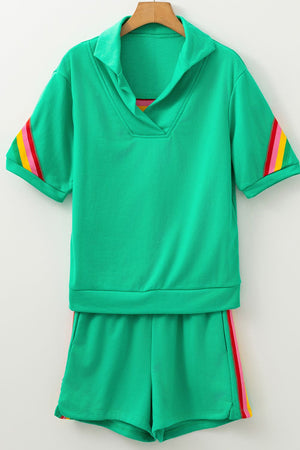 Green activewear shorts and top set with rainbow stripe details on sleeves and shorts.