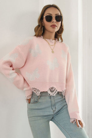 Blush pink acrylic knit sweater with white butterfly intarsia, frayed hem and cuffs, cropped length.
