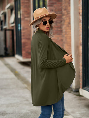 Moss green draped cascade cardigan with long sleeves and open front, styled with jeans and a hat.