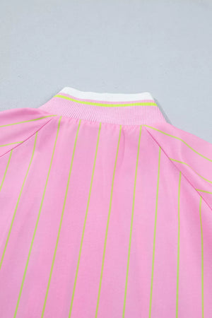 Pink striped polo shirt with a white and green striped collar detail.