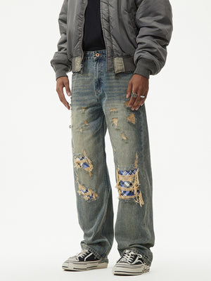 Distressed denim wide leg jeans with blue plaid patches and ripped details.