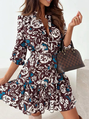 Brown floral tie-waist mini dress with button-down front and ruffled hem.