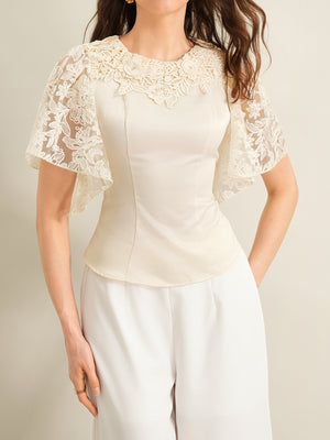 Apricot lace trimmed short sleeve blouse with floral neckline detail.