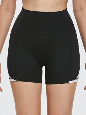 Black sculpted shorts with white side stripe detail and pockets.