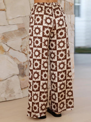 Brown checkerboard sunburst co-ord set pants with wide legs.