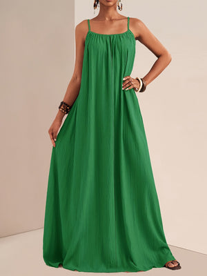 Green crinkled maxi dress with spaghetti straps and empire waist, perfect for maternity wear.