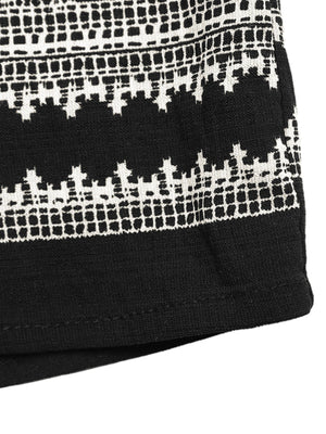 Black sleeveless top with white geometric print detail and solid hem