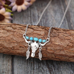 Silver necklace with turquoise bull head and feather charms